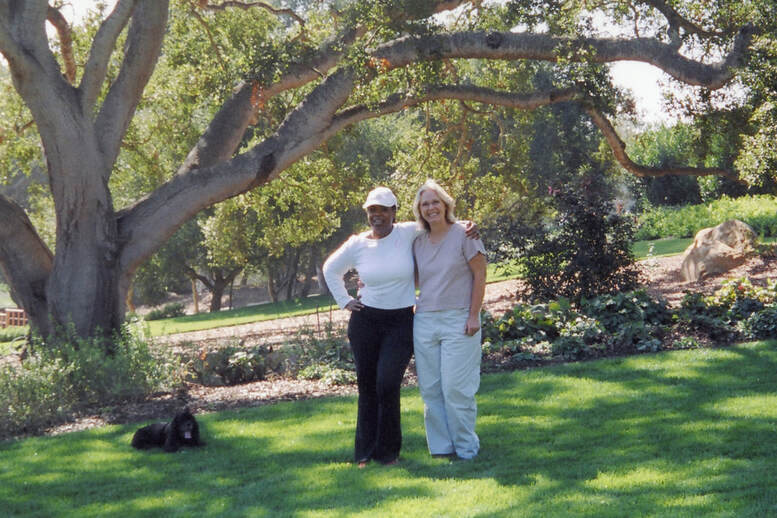 The artist Jamie Santaniello standing with Ms. Winfrey and her dog Sophie under her favorite oak tree on her Montecito, California Estate Oprah calls her 